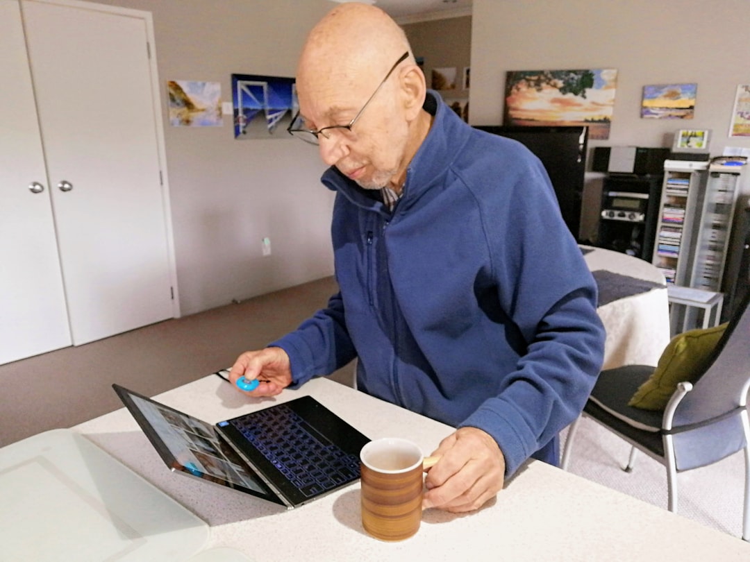  homeowner using a laptop for a virtual energy assessment