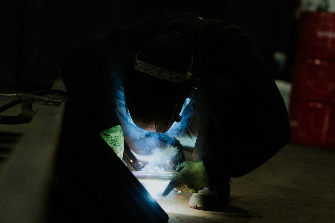  HVAC technician sealing duct joints with mastic